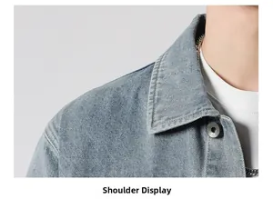 Detailed view of washed denim jacket shoulder seams and engraved metal button detail