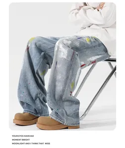 Detail of light blue washed graffiti jeans featuring colorful paint splatters and art print
