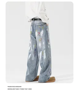 Detail of light blue wide-leg jeans with multi-color graffiti paint splatters and street style