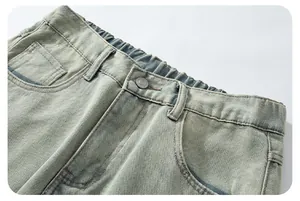 Detailed macro view of retro washed blue denim jeans featuring an elastic waist and metal button