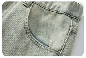 Macro view of vintage washed denim pocket with reinforced double brown stitching