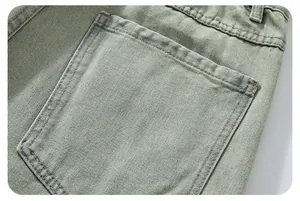 Detailed macro shot of vintage wash denim pants featuring square back pockets and double stitching