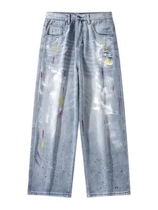 Light blue straight-leg graffiti jeans with multi-color paint splatters and distressed holes