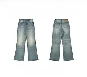Detail view of vintage washed blue flared denim pants with front and back pocket styling