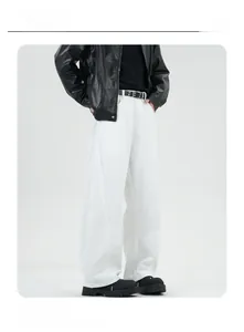 Detail of loose fit white straight-leg trousers with heavy fabric drape and street style