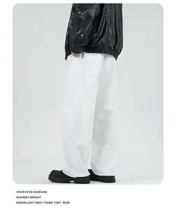 Detail view of white wide-leg jeans featuring vintage stitching and loose fit design