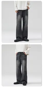 Détail du denim délavé gris foncé avec moustaches et coupe large de style décontracté