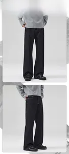 Detail showing the cleanfit wide-leg black denim pants with textured fabric and drape