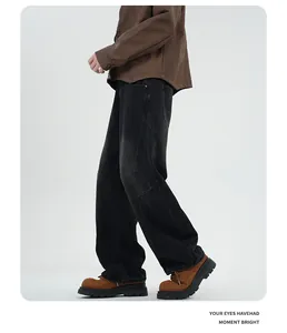 Detailed side view of loose fit washed black jeans with vintage distressed panelling