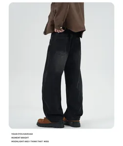 Rear view of loose fit vintage washed denim pants with curved stitching and back pockets