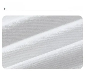 Macro shot of white twill denim fabric texture with soft folds and weave details