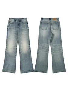 Vintage washed light blue flared jeans with whiskers and leather patch detail for men and women