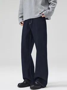 Classic dark blue loose fit straight leg raw denim jeans in a clean minimalist style