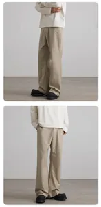 Detail view of khaki flared trousers showing fabric drape and cleanfit styling
