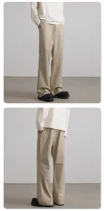 Detail shot of khaki flared trousers showing structural stitching and premium fabric drape