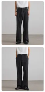 Detail view of black wide-leg tailored trousers with premium drape and side pockets