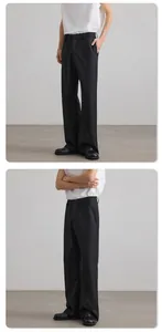 Detail view of black wide-leg trousers with premium drape and clean-fit minimalist design
