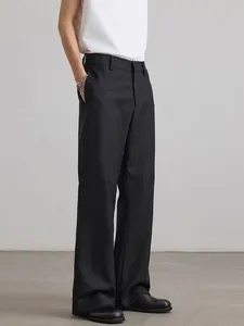 Men's black wide-leg trousers with minimalist deconstructed cut and draped fabric