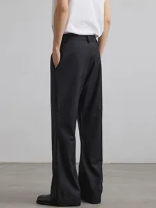 Minimalist black wide-leg trousers with high-waist cut and premium drape tailoring