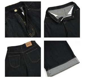 Detail of dark indigo denim jeans featuring contrast stitching and leather brand patch