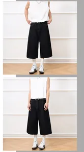 Detailed view of heavy-duty black wide-leg denim shorts on model for street casual style