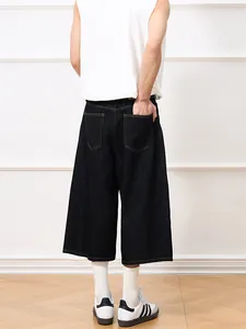 Mens dark indigo wide-leg denim capris with back pockets shown from a back view