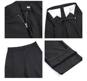 Viste dettagliate dei pantaloni neri larghi con cerniera in metallo, vita e tasche