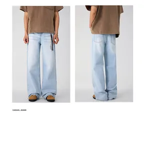 Detail of light blue washed straight-leg denim jeans with classic pockets and cleanfit style