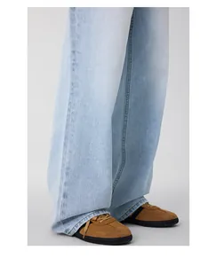 Close-up of light blue wide-leg denim jeans with washed effect and retro casual style