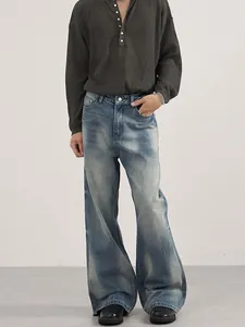 Retro washed blue flared denim jeans for men featuring vintage faded texture and clean fit