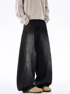 Vintage washed black baggy jeans with a wide-leg cut and distressed denim texture