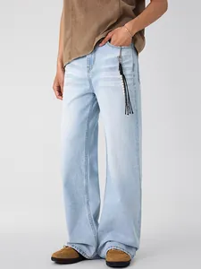 Light blue straight leg denim jeans with a relaxed American vintage aesthetic and tassel detail