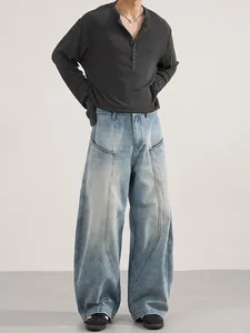 Men's retro loose baggy jeans with unique curved stitching and grey long sleeve henley shirt