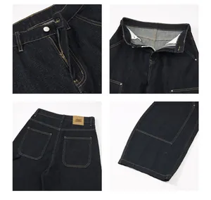 Detail of dark denim workwear pants with yellow stitching and leather waist tag