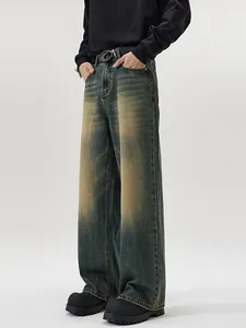 Men's vintage washed wide-leg denim jeans in distressed deep blue with yellow fade