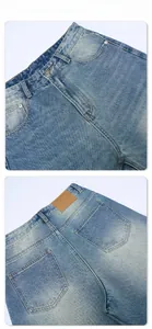 Macro detail of vintage washed gradient denim jeans with leather back patch and stitching
