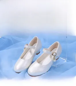 Détail de chaussure Mary Jane crème pour fille avec pendentif perle et boucle dorée