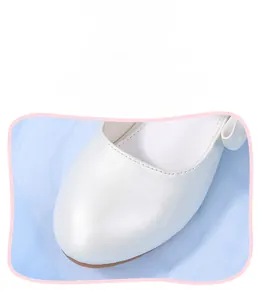Detail of white microfiber leather texture and stitching on girls' princess shoes