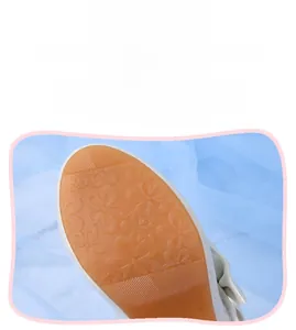 Close-up of non-slip rubber sole with floral texture on girls white princess shoes