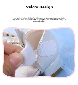 Detail of white girls' shoes with pearl embellishment and adjustable velcro strap closure