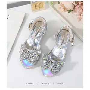 Detail of silver glitter girls sandals with colorful rhinestone bow and rainbow insole