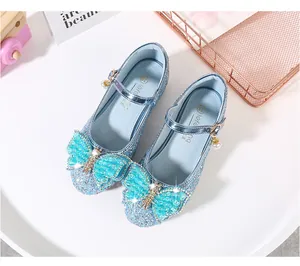 Close-up of girls blue sequin Mary Jane shoes with large bow and rhinestone charms