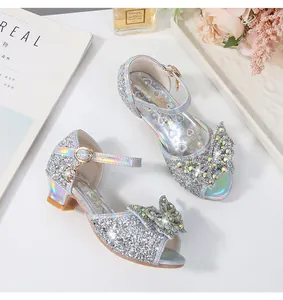 Detail of silver sequin girls princess sandals with sparkling bow and rhinestone accents