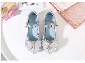 Detailed top view of silver glitter Mary Jane shoes with crystal butterfly and pearl accents