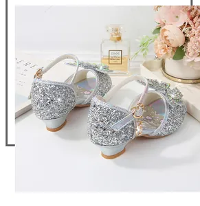 Detailed view of silver glitter girls princess shoes with rhinestone bow and heart charm