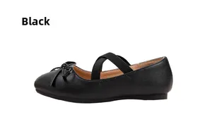 Detail of girls' black matte Mary Jane flats with bow and elastic cross straps