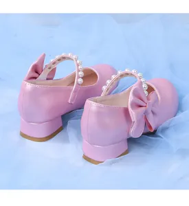 Pink Mary Jane shoes with pearl strap and large bow detail for girls party dress