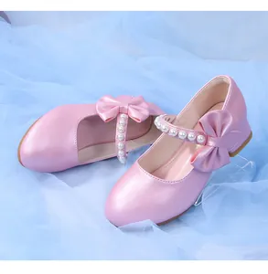 Detail of pink pearl leather girls shoes with bow and pearl strap for formal party