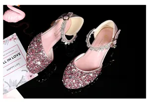 Detail of pink sequin girls dress shoes with rhinestone buckle and shimmering finish