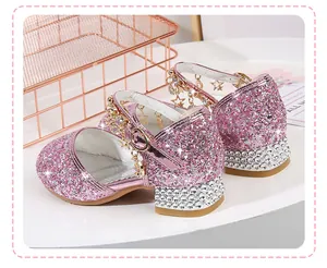 Detail view of pink glitter girl's shoes with rhinestone heels and star charm